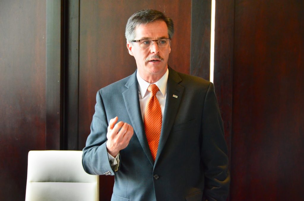 Peter Hall presenting in an executive boardroom