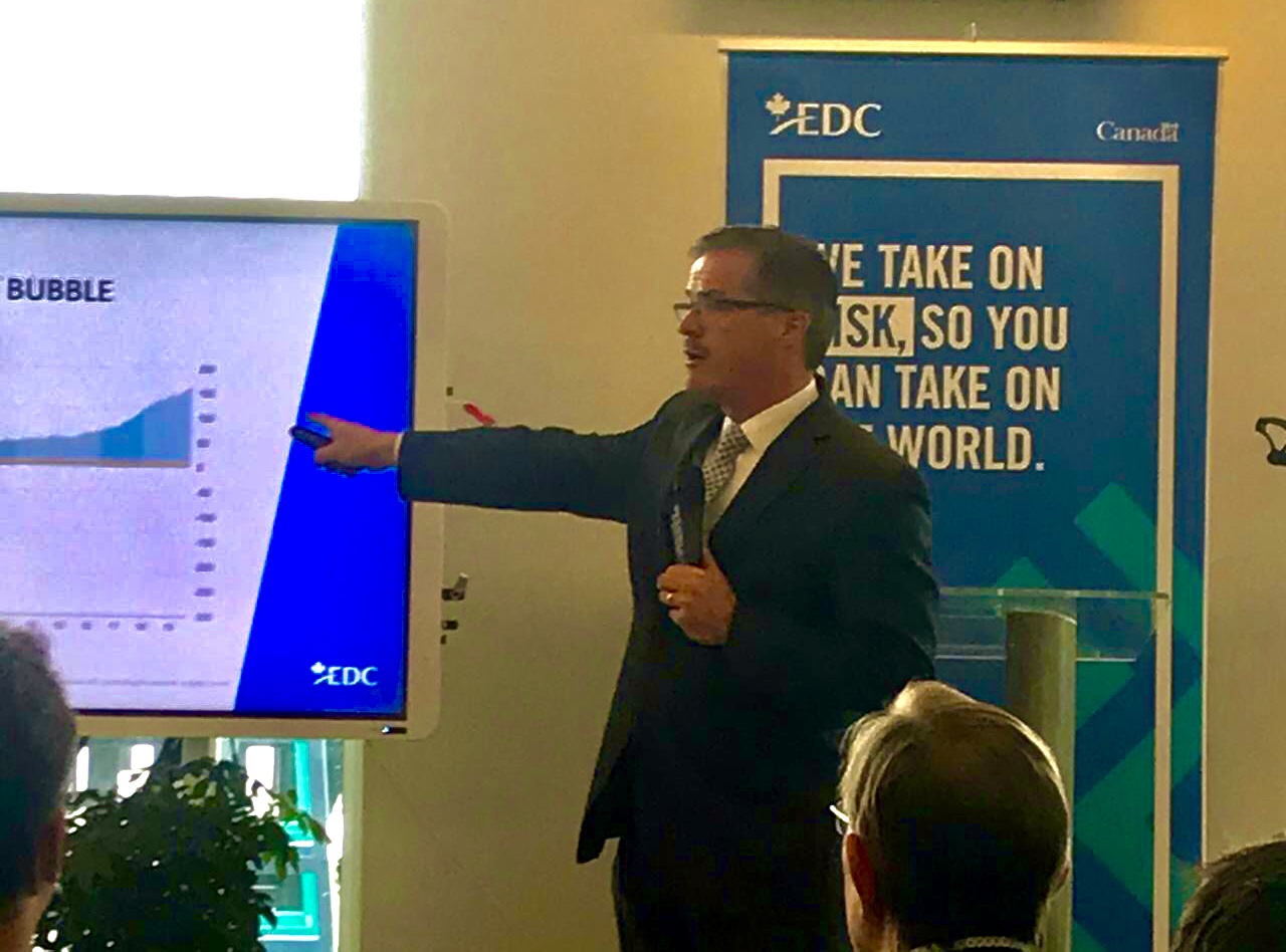 Peter Hall presenting economic charts at an EDC event