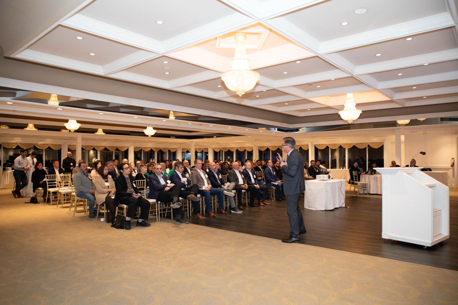 Peter Hall delivering a keynote to a ballroom audience.